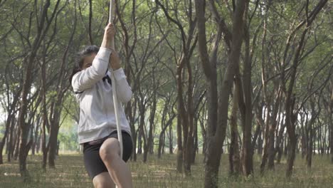 a sporty gymnast performs exercises with a rope in sportswear