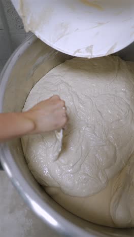 preparing dough in a mixing bowl