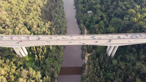 drone pan aerial shot of mooney mooney creek bridge big dipper m1 motorway freeway with car traffic to sydney from central coast hawkesbury river nsw australia 3840x2160 4k