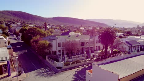 an enchanting aerial view captures a montagu hotel from the front, nestled against a backdrop of majestic mountains and rolling hills, offering a serene escape