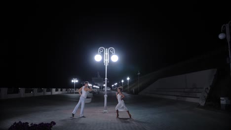 couple dancing at night on the street