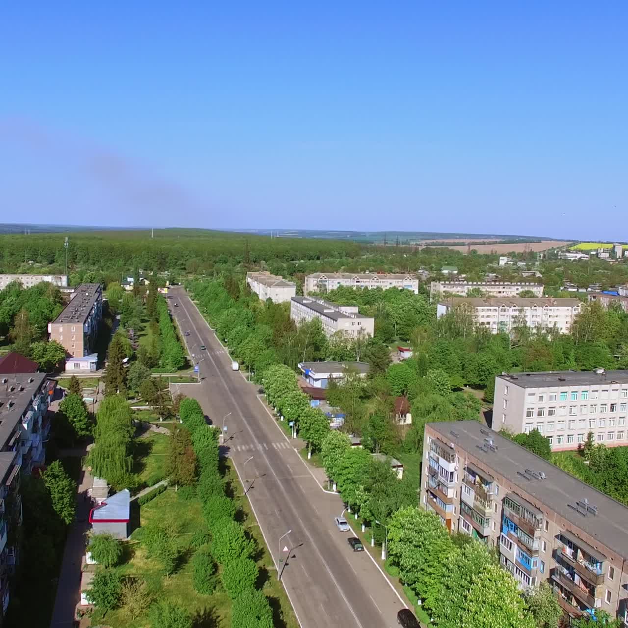 Residential area with numerous blocks of flats. Drone flying over the green streets of little Ukrainian town