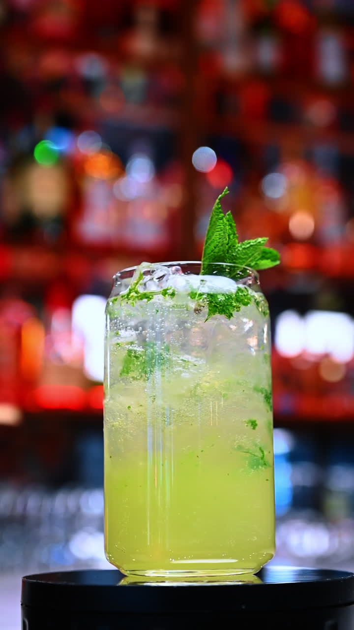 Mojito with mint and ice. A tall glass of mojito filled with mint leaves, ice and sparkling lime mixture