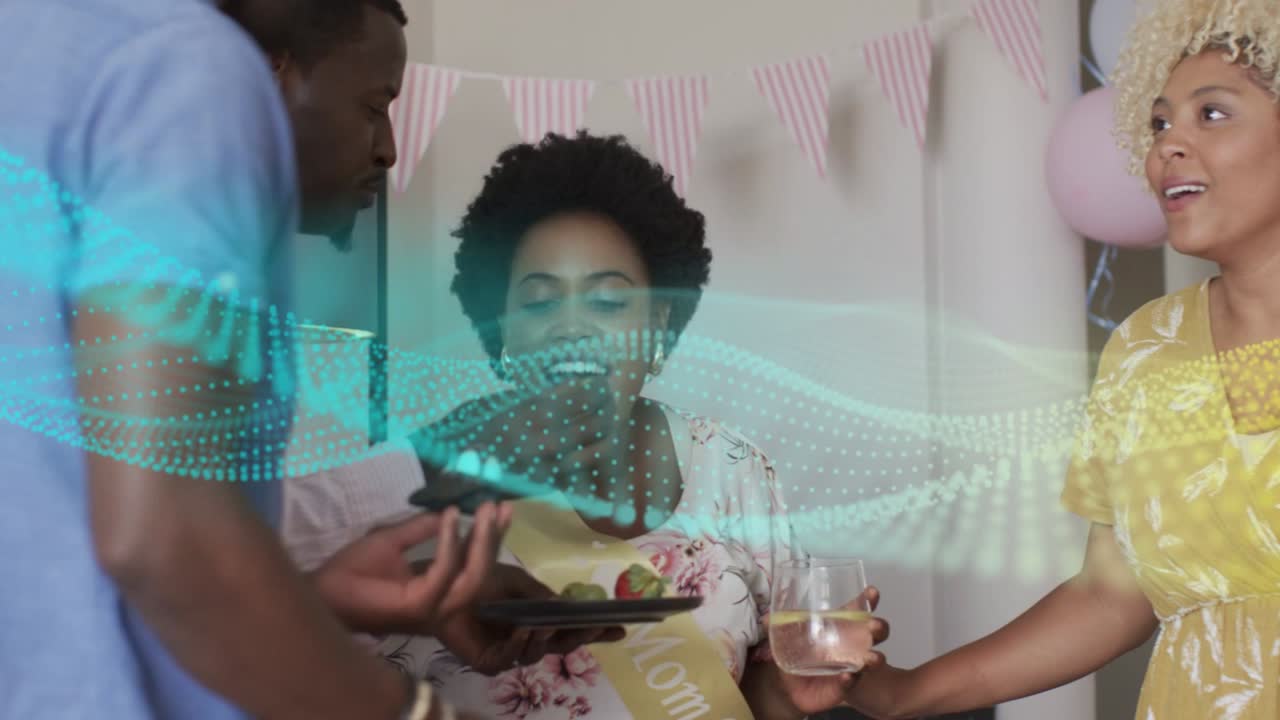 Mom-to-be wearing sash being fed cupcake after guest offering at shower, waveform moving over faces