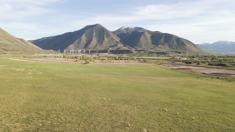 AERIAL---Mountain-range-and-a-wind-power-farm,-Spanish-Fork,-Utah,-wide-shot