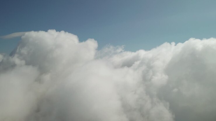 Flying above beautiful thick fluffy clouds