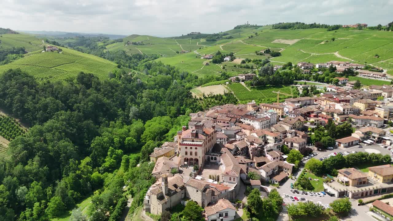 Barolo Castle in Langhe Wine Region, Cuneo, Piedmont, Italy. 4K Aerial view of the village and the vineyards, circling to the left, wide open view of the town.