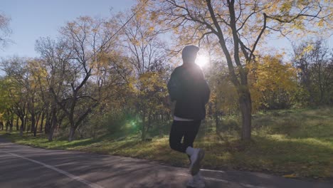 man running in autumn park