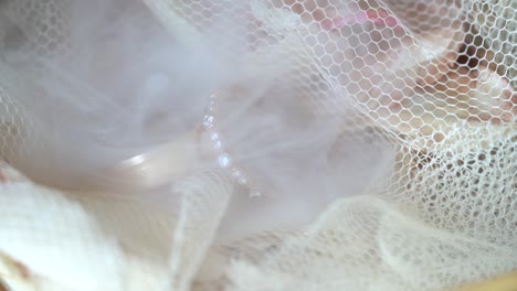 smoke blowing on macro wedding rings in slow motion