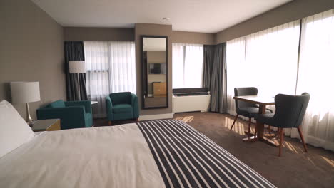 this hotel room offers a comfortable and spacious accommodation with a king-size bed, plush bedding, and soft pillows