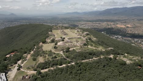 Sunny-day-aerial-to-Monte-Alban-Zapotec-temple-ruins-in-Oaxaca,-Mexico