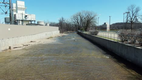 Creek-with-low-water-supply-in-Kaukauna-Wisconsin,-sunny-day-early-spring