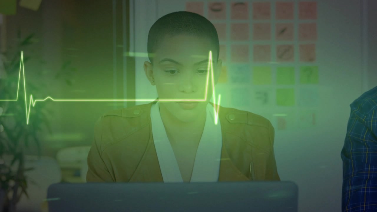Animation of lifeline over women using laptop