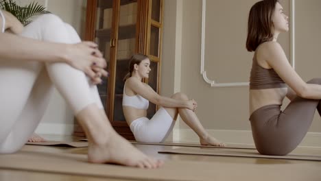 women practicing yoga seated poses