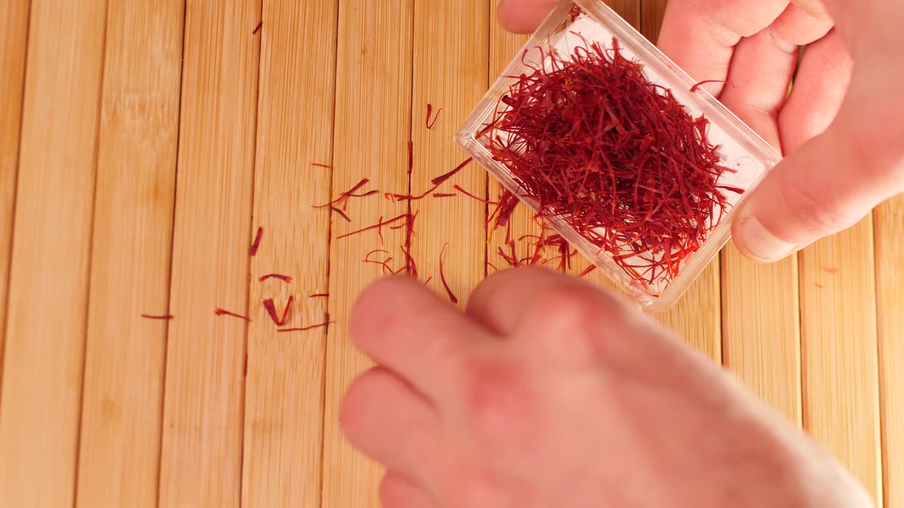 Placing saffron threads in plastic container