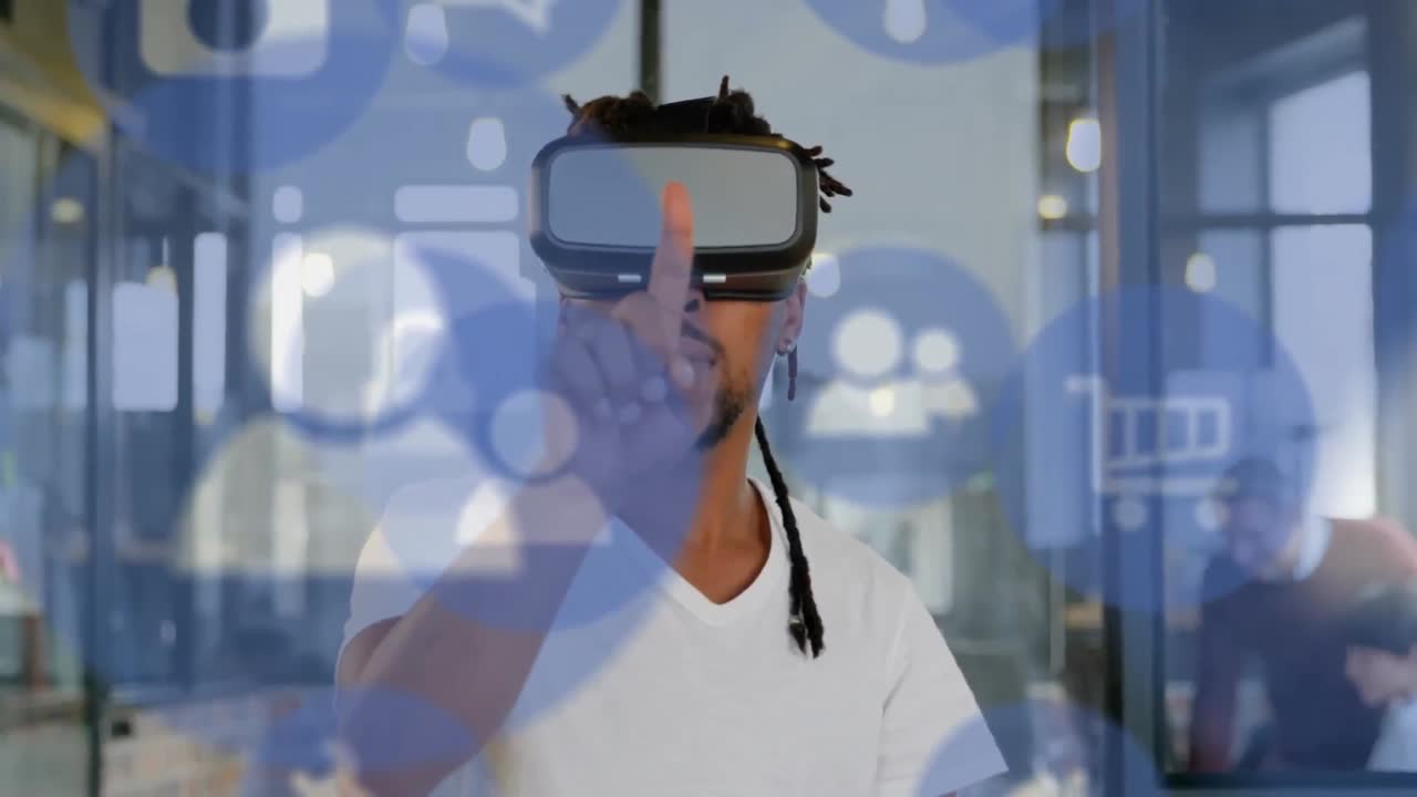 Multiple digital icons floating against african american businessman wearing vr headset at office