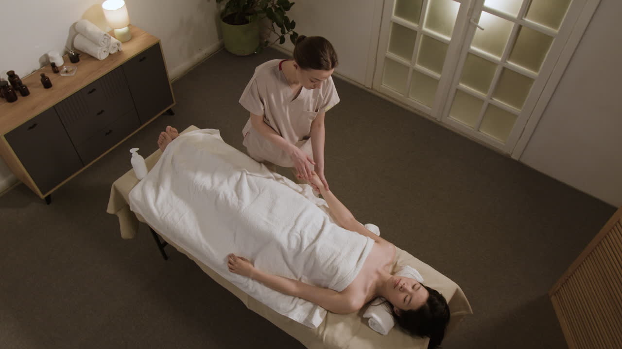 Woman receiving a relaxing full body massage in a spa