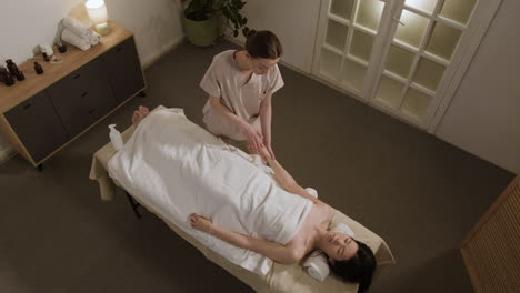 woman receiving a relaxing full body massage in a spa