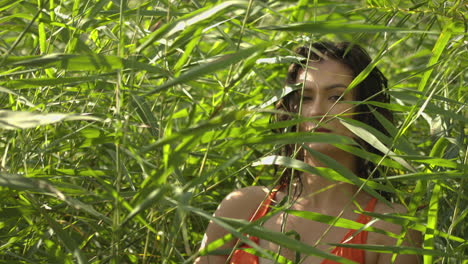 a young woman in the bulrush looks at the camera