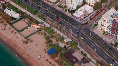 Aerial-shot-of-a-tram-waiting-at-a-road-junction-Athens
