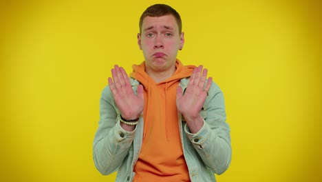 man on yellow studio background pointing fingers himself ask say who me no thanks i do not need it