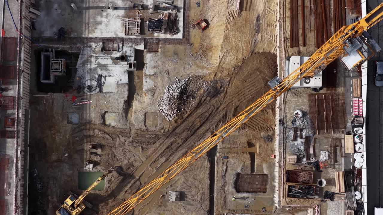 Drone shot of construction site in progress. Crane