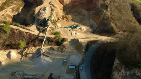 large bulldozer drives back and forth on an industrial site where raw materials are extracted