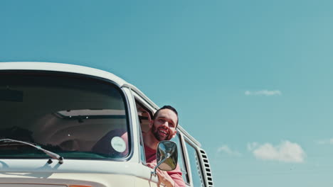 Road-trip,-blue-sky-and-man-with-thumbs-up-in-van