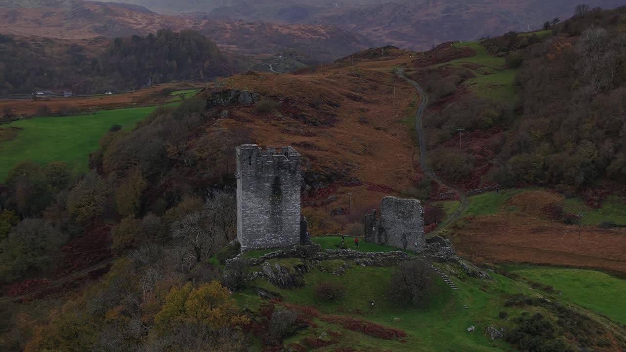 Aerial drone video of Dolwyddelan Castle in Snowdonia National Park, showing the medieval hilltop ruins and the dramatic Welsh highland landscape surrounding this historic stronghold