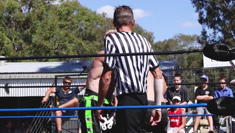 wrestlers competing in an outdoor wrestling ring