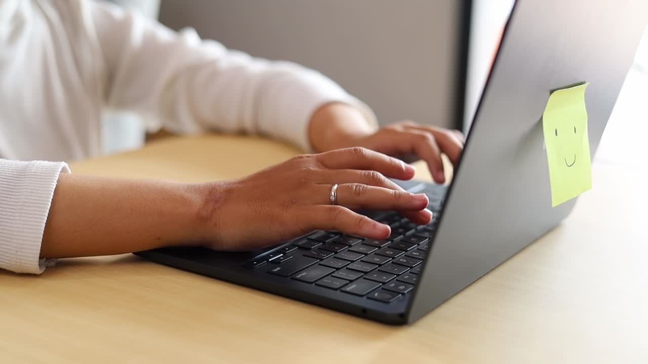 Businesswoman hands writing typing email or working on laptop at home. Close up