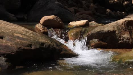 tranquil scene of clean water flowing from a spring that shows the concept of healing in nature, cleansing, mental health and letting go