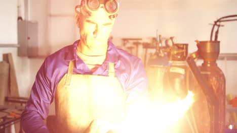 Welder-working-in-workshop