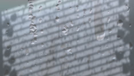 animation of raindrops over window shadow on grey background