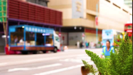 tram passes cyclist on busy hong kong street