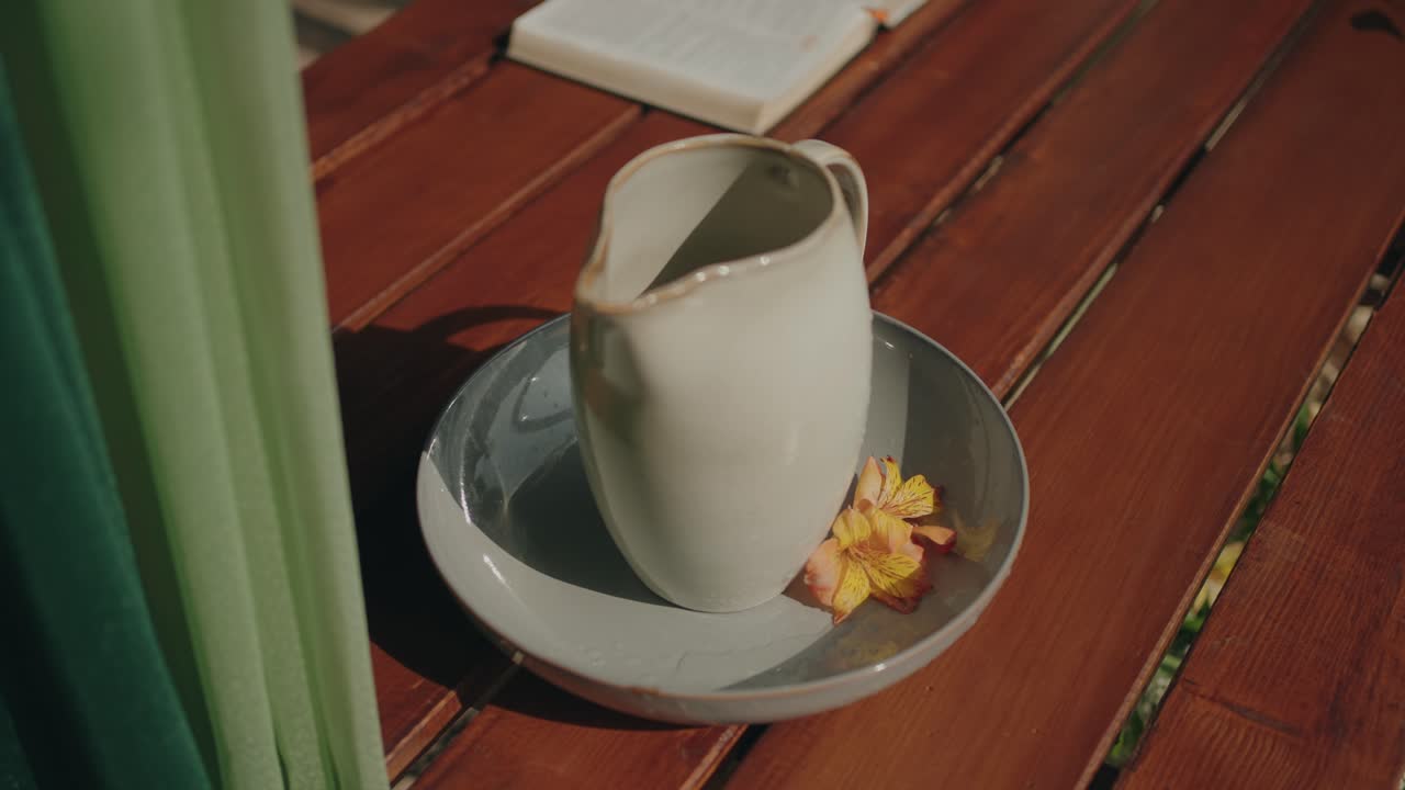 Ceramic jug and bowl with flower prepared for symbolic foot washing ritual