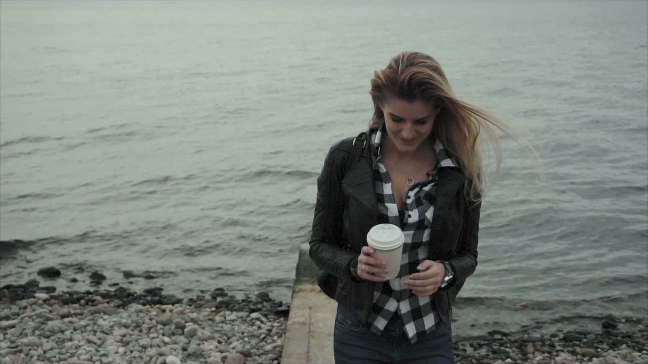 Woman with Coffee on the Beach