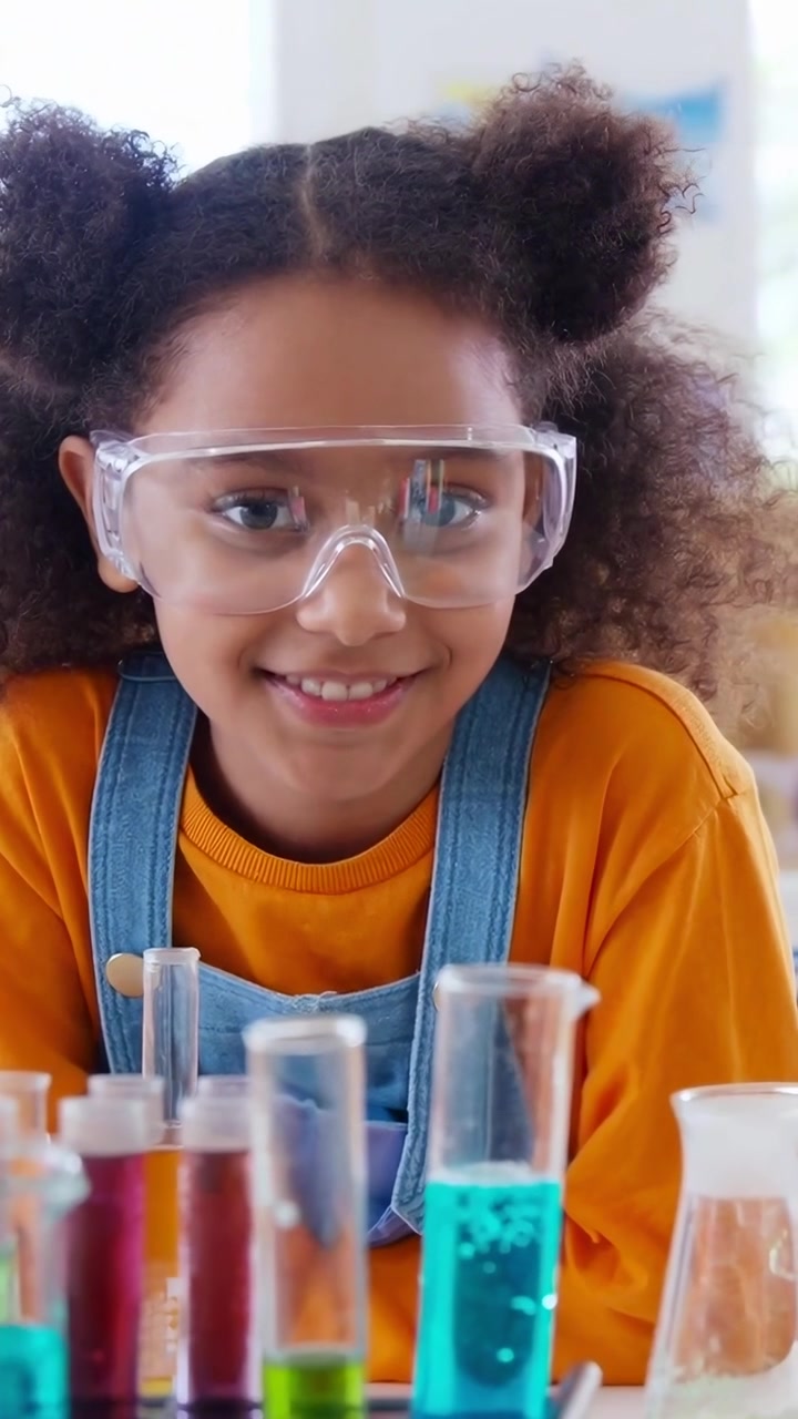 Young Girl Wearing Safety Goggles Conducting Science Experiment