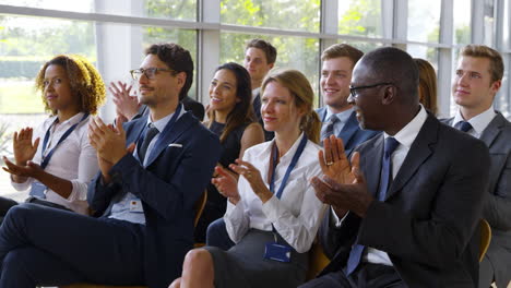 delegates at business conference applauding speaker