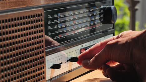 old retro am fm radio with tubes, hand changing stations , bulb vintage music player.