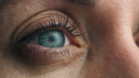 a striking close-up of a blue eye captures every detail of the iris and surrounding skin