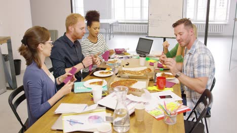 colleagues enjoying pizza