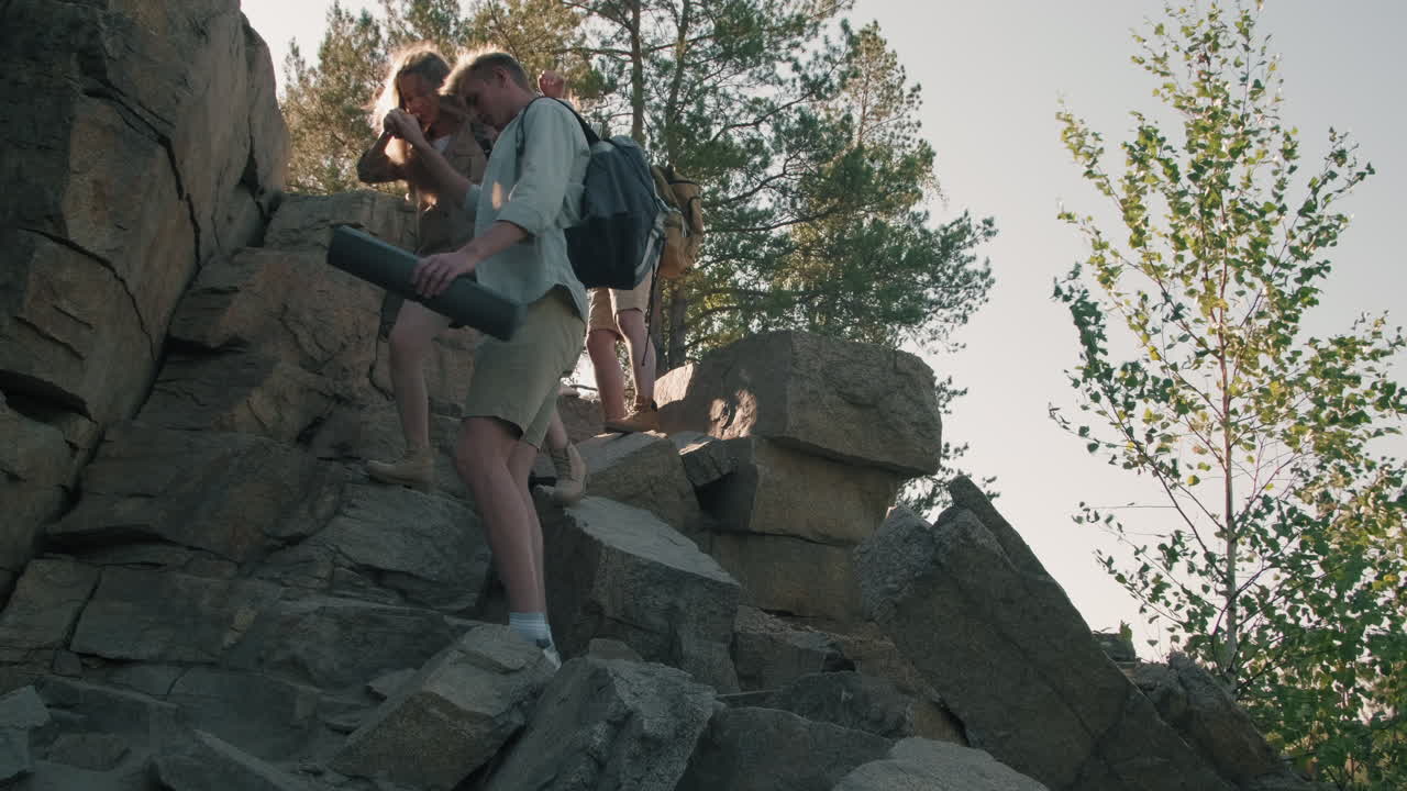 Couples Hiking Down Cliff