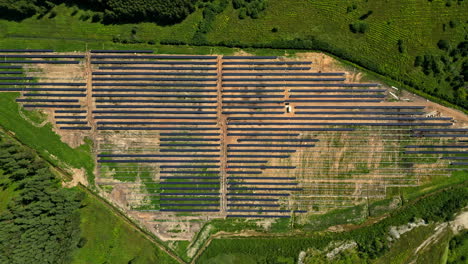 top down drone shot above a photovoltaic panel project, large solar energy plant