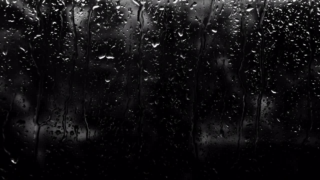 Raindrops in the dark. Rain outside the window, background of water drops on glass