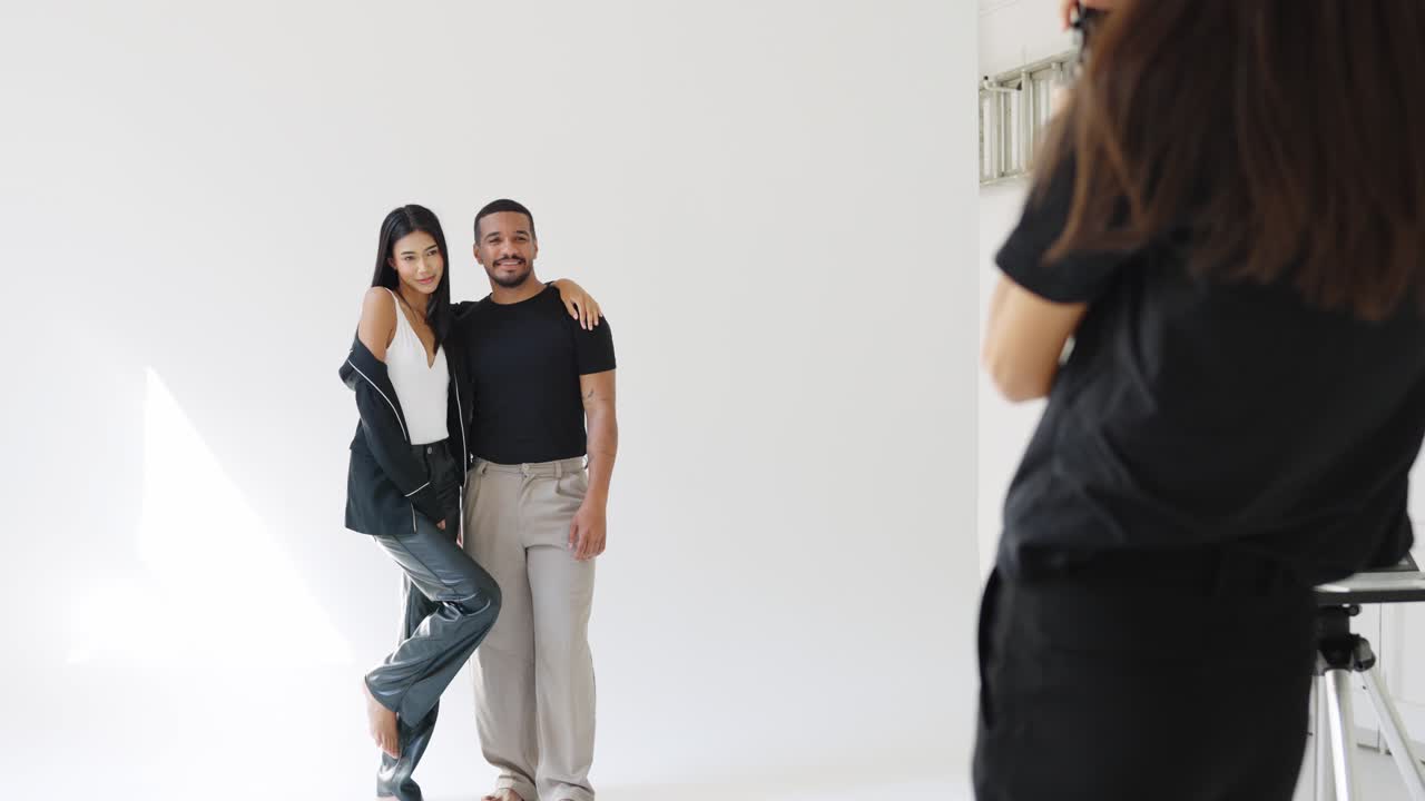 Fashion photoshoot with a couple and photographer in the studio