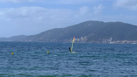 windsurfer surfing in the waters of ajaccio bay on a beautiful sunny day