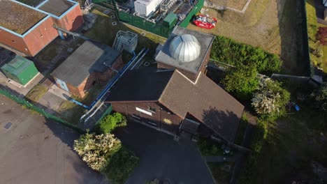 aerial view looking down at pex hill leighton observatory silver dome rooftop on hilltop farmland at sunrise