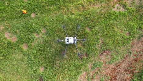 drone dji agras t30 comenzando desde tierra en el aire vista de arriba hacia abajo