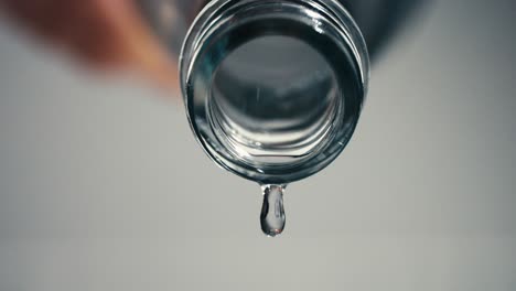 stay hydrated, one last drop of water falling from an empty water bottle, highspeed, slowmotion, closeup